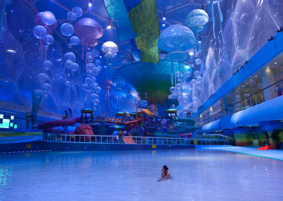 A patron sits in the wave pool at the Happy Magic Water Cube, Beijing Water Cube Water Park. - Beijing
