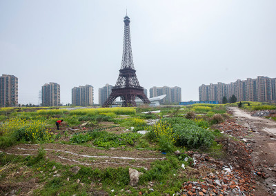 Tianducheng residents farm the largely abandoned field surrounding the Eiffel Tower. - Hangzhou, Zhejiang