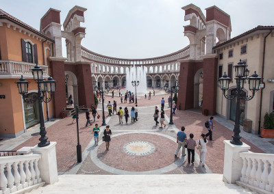 A faux Colosseum rises above the Florentia Village shopping mall. - Tianjin