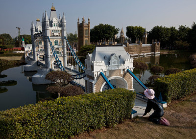 A child crawls onto a mock London Bridge at the Window of the World theme park. - Shenzhen, Guangdong
