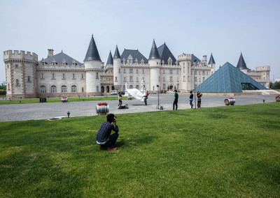 A couple poses for wedding photographs in front of Chateau Dynasty which is modeled after Château de Montaigne in France. - Tianjin