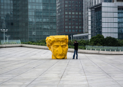 A tourist photographs a sculpture in Zhujiang New Town. - Guangzhou, Guangdong