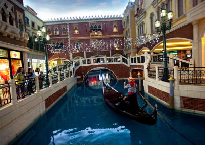 A gondola drifts down an indoor canal in the shopping mall of The Venetian. - Macau