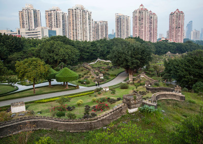 A mock Great Wall runs below megablock developments in the Splendid China theme park. - Shenzhen, China
