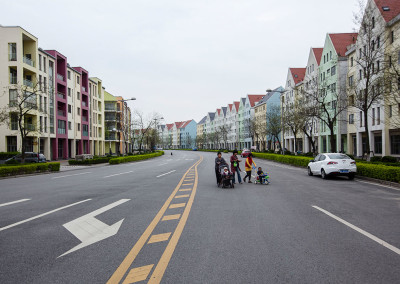 Residents take their children for a stroll in the faux-German Weimar Village designed by Alfred Speer. - Shanghai