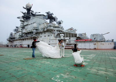 A couple poses for wedding photographs on the deck of the Minsk World military theme park. - Shenzhen, Guangdong