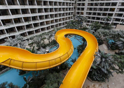 The huge slides at Paradise Island water park run beneath Intercontinental hotel rooms still under construction. - Chengdu, Sichuan